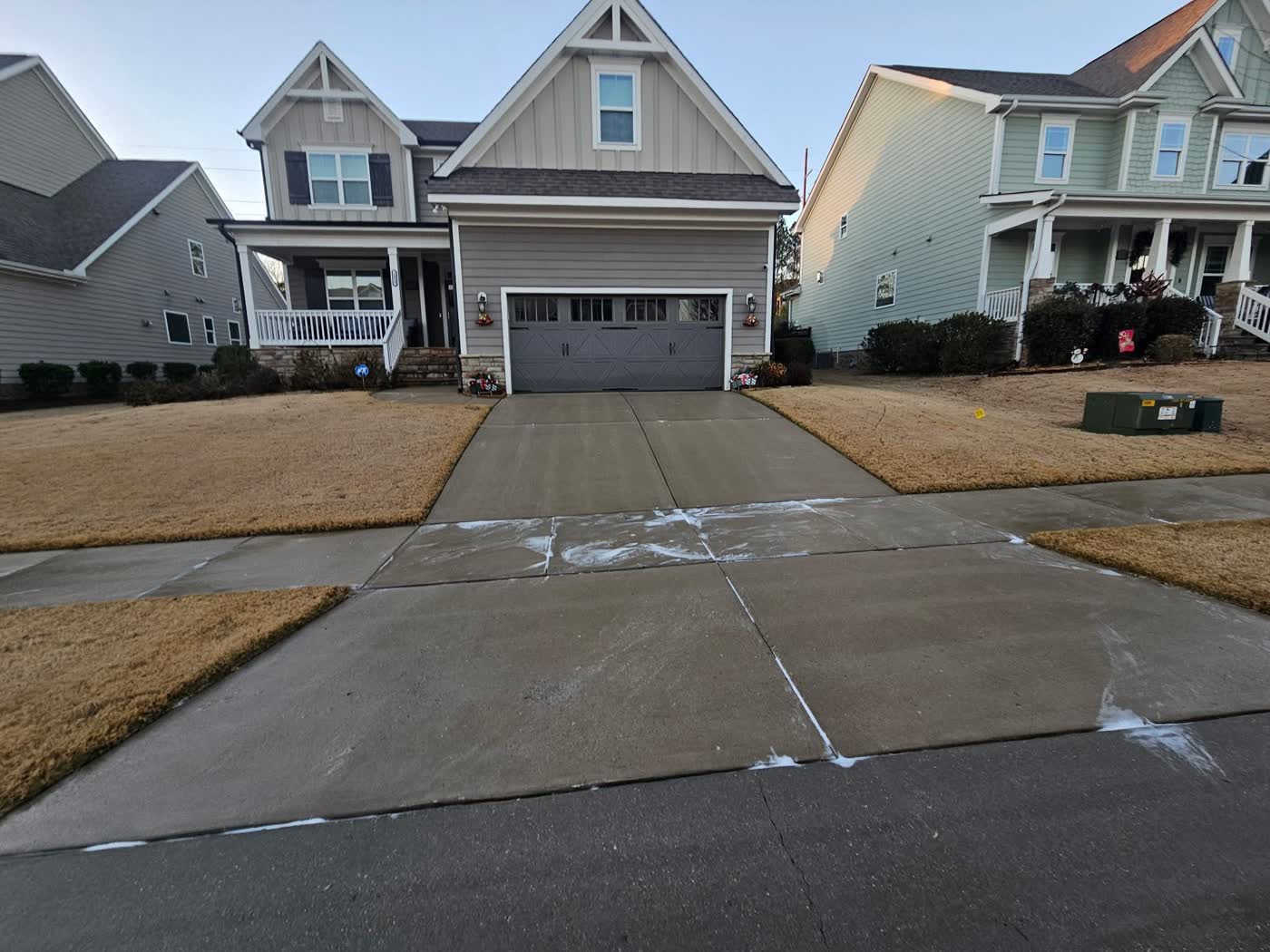 Freshly cleaned concrete driveway in front of a Triangle home