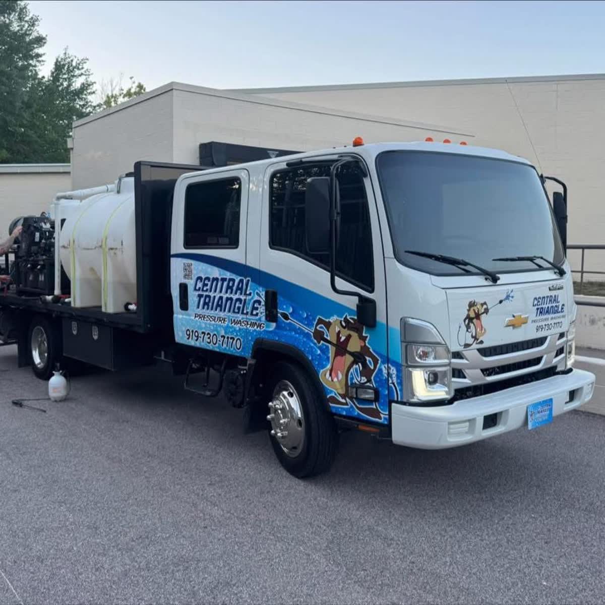 Central Triangle Pressure Washing truck with its own water supply parked at a commercial job
